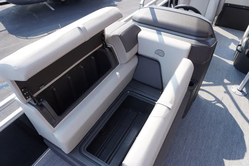 Slide: The Image of Sun Tracker Fishin' Barge 20 DLX 2027, open storage compartment, gray seating, boat interior. - 8