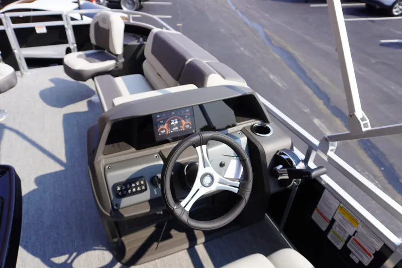 Slide: The Image of 2027 Sun Tracker Fishin' Barge 20 DLX helm with modern controls and comfortable seating. - 11