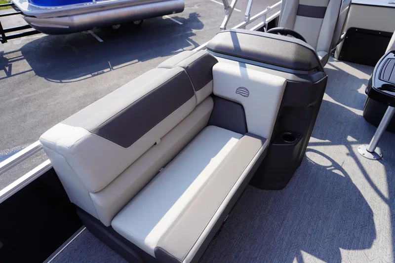 Slide: The Image of 2027 Sun Tracker Fishin' Barge 20 DLX interior seating with gray upholstery and cup holder. - 7