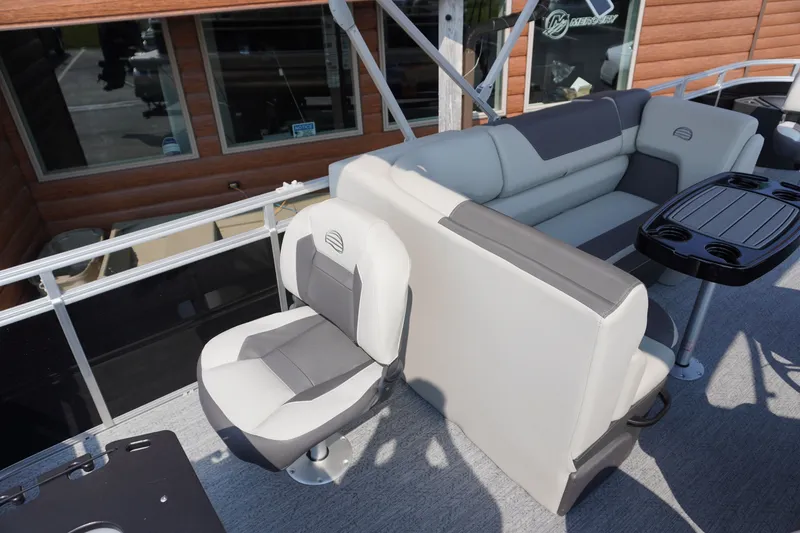 Slide: The Image of 2027 Sun Tracker Fishin' Barge 20 DLX interior with seating and table setup. - 14
