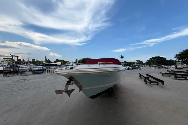 Slide: The Image of 2005 Chris-Craft Corsair 25 boat on dry dock under a clear blue sky. - 13