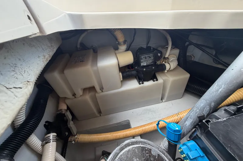 Slide: The Image of Engine compartment of a 2005 Chris-Craft Corsair 25 boat, showcasing mechanical components. - 63