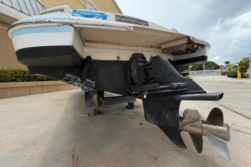 Slide: The Image of 2005 Chris-Craft Corsair 25 boat, rear view showing propeller and hull details. - 14