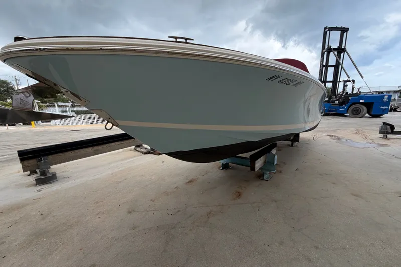 Slide: The Image of 2005 Chris-Craft Corsair 25 boat on dry dock, showcasing sleek hull design. - 8