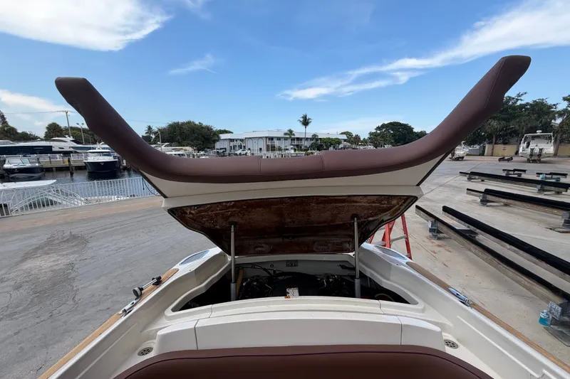 Slide: The Image of 2005 Chris-Craft Corsair 25 boat with open engine compartment, dockside view. - 59