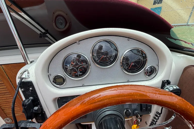 Slide: The Image of Dashboard of a 2005 Chris-Craft Corsair 25 boat with wooden steering wheel. - 36