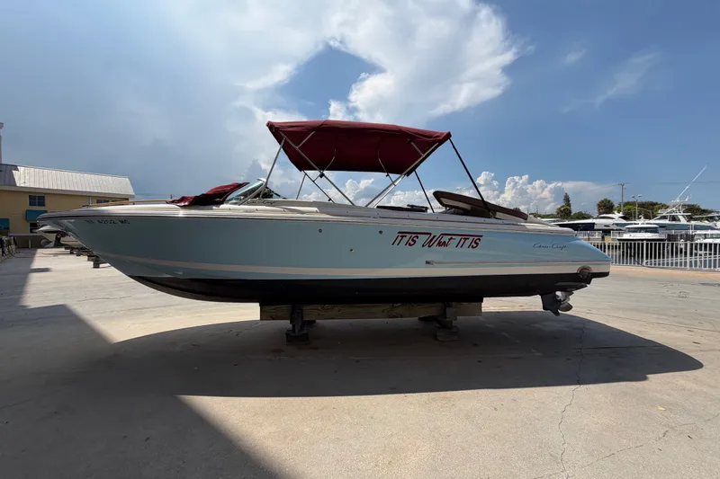 Slide: The Image of 2005 Chris-Craft Corsair 25 boat with red canopy on a sunny day. - 19