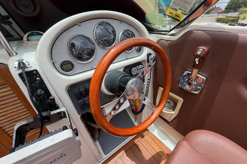 Slide: The Image of 2005 Chris-Craft Corsair 25 dashboard with wooden steering wheel and instrument panel. - 39
