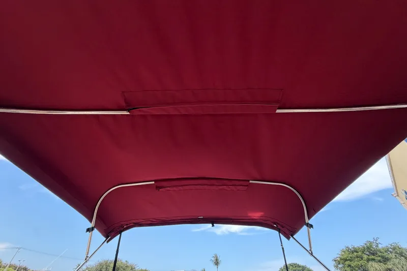 Slide: The Image of Maroon canopy of 2005 Chris-Craft Corsair 25 boat against blue sky. - 21