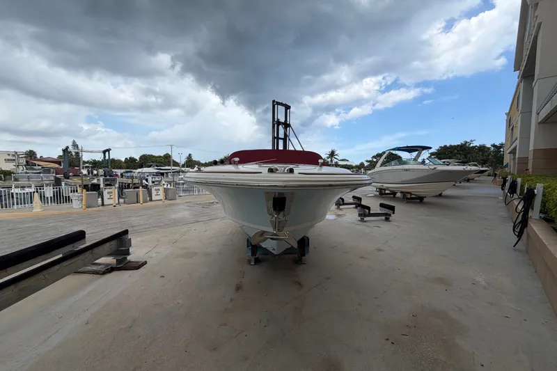 Slide: The Image of 2005 Chris-Craft Corsair 25 boat on a dock under cloudy skies. - 6