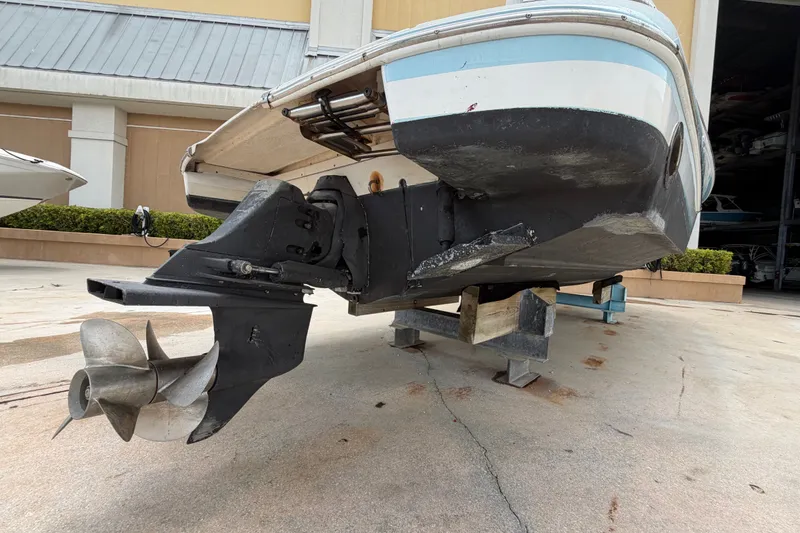 Slide: The Image of 2005 Chris-Craft Corsair 25 boat on dry dock, showcasing propeller and hull details. - 16