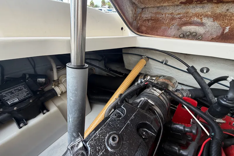 Slide: The Image of Engine compartment of a 2005 Chris-Craft Corsair 25 boat, showcasing mechanical components. - 64