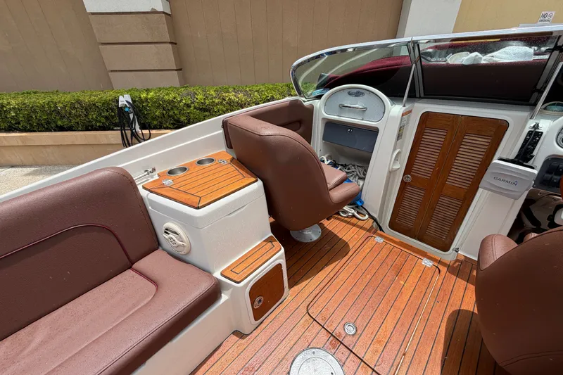 Slide: The Image of 2005 Chris-Craft Corsair 25 boat interior with brown seating and wooden accents. - 31