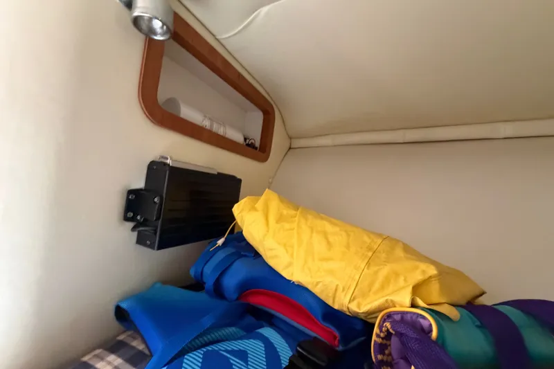 Slide: The Image of Interior cabin of 2005 Chris-Craft Corsair 25 with life jackets and storage. - 49
