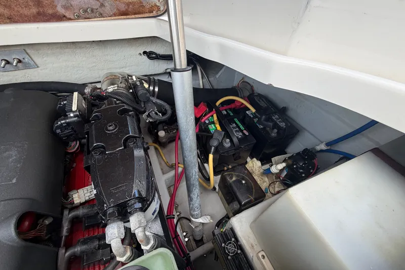 Slide: The Image of Engine compartment of a 2005 Chris-Craft Corsair 25 boat, showing batteries and wiring. - 66