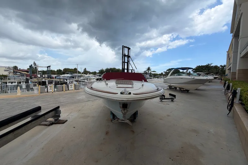 Slide: The Image of 2005 Chris-Craft Corsair 25 boat on dry dock under cloudy sky. - 7