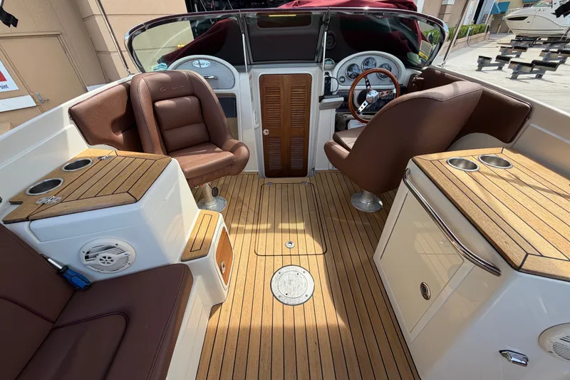 Slide: The Image of 2005 Chris-Craft Corsair 25 interior with teak flooring and leather seating. - 38