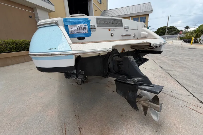 Slide: The Image of 2005 Chris-Craft Corsair 25 boat rear view, showcasing propeller and hull details. - 13