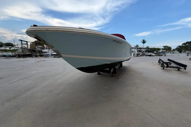 Slide: The Image of 2005 Chris-Craft Corsair 25 boat on dry dock under a blue sky. - 14