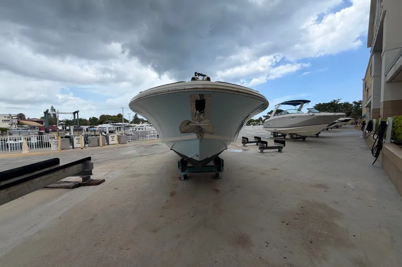 Slide: The Image of 2005 Chris-Craft Corsair 25 boat on dry dock under cloudy sky. - 5
