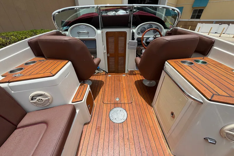 Slide: The Image of 2005 Chris-Craft Corsair 25 interior with wooden deck and leather seating. - 29