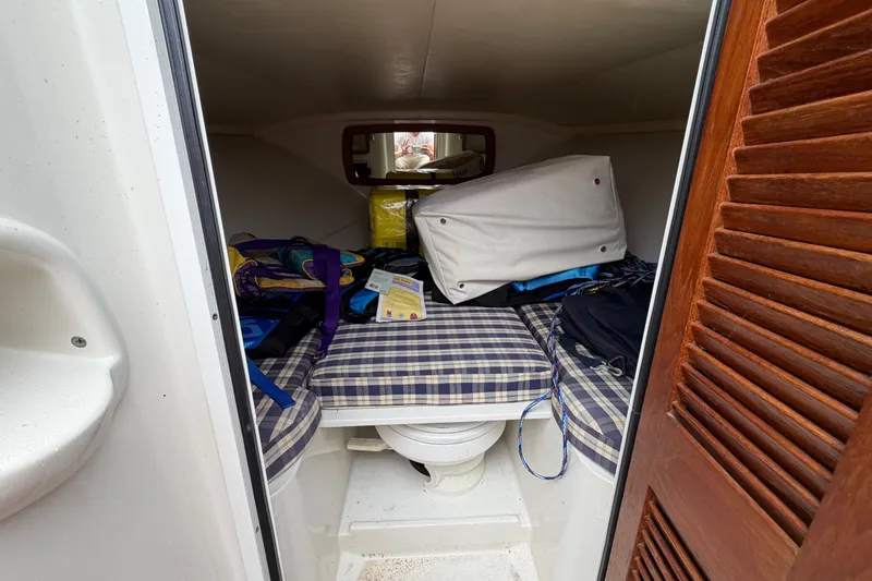 Slide: The Image of 2005 Chris-Craft Corsair 25 cabin interior with cushions and storage items. - 45