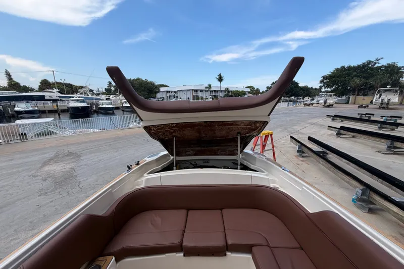 Slide: The Image of 2005 Chris-Craft Corsair 25 boat with open engine hatch at marina. - 58