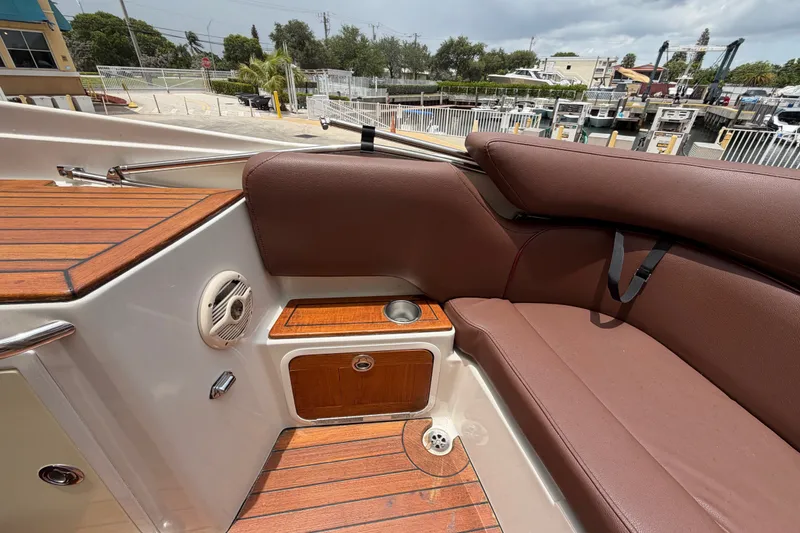 Slide: The Image of 2005 Chris-Craft Corsair 25 interior with brown seating and wood accents. - 24