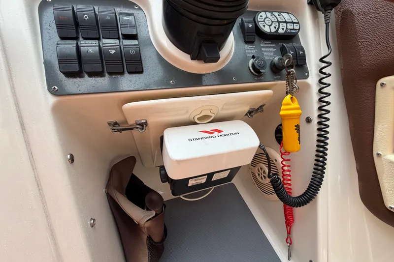 Slide: The Image of 2005 Chris-Craft Corsair 25 dashboard with control panel and Standard Horizon equipment. - 40