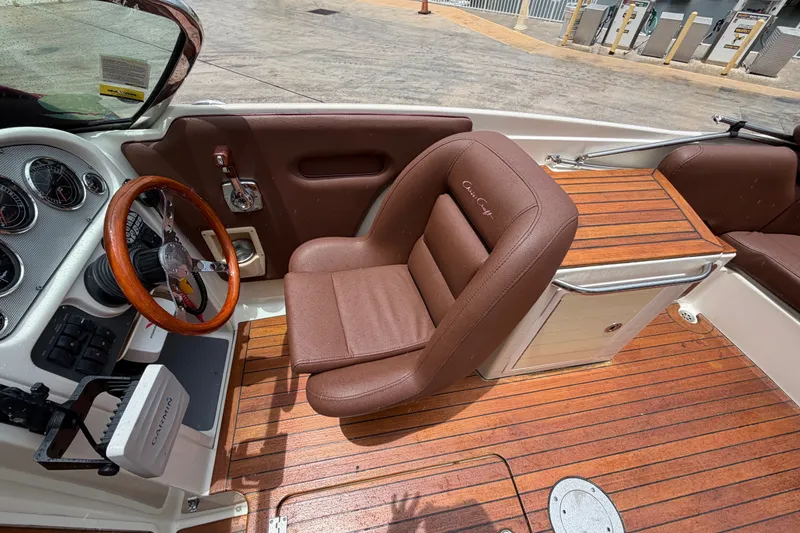 Slide: The Image of 2005 Chris-Craft Corsair 25 cockpit with brown leather seating and wooden steering wheel. - 41