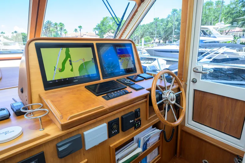 Slide: The Image of 2018 Sabre 45 Salon Express helm with dual navigation screens and wooden steering wheel. - 38