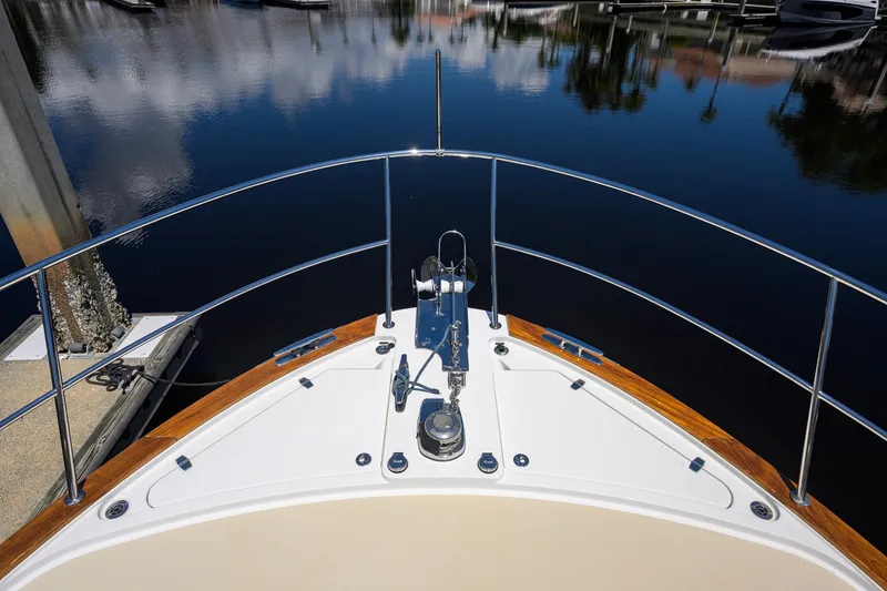 Slide: The Image of Bow view of 2018 Sabre 45 Salon Express yacht docked in calm waters. - 76