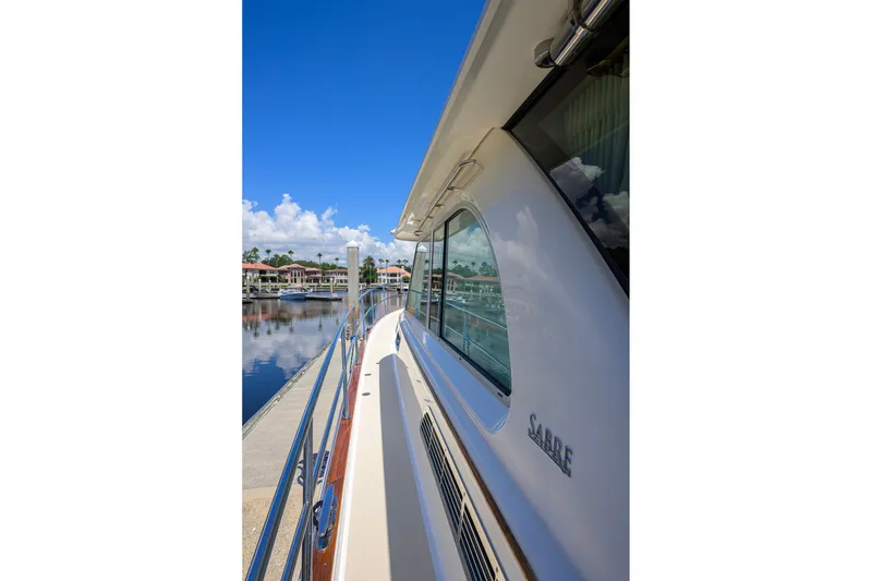 Slide: The Image of 2018 Sabre 45 Salon Express yacht docked, showcasing sleek design and waterfront view. - 73