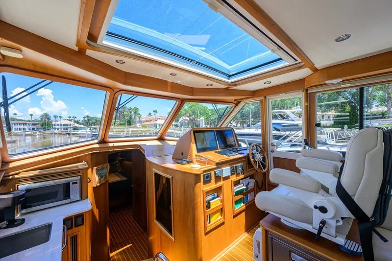 Slide: The Image of Interior of 2018 Sabre 45 Salon Express yacht with helm, seating, and panoramic windows. - 42