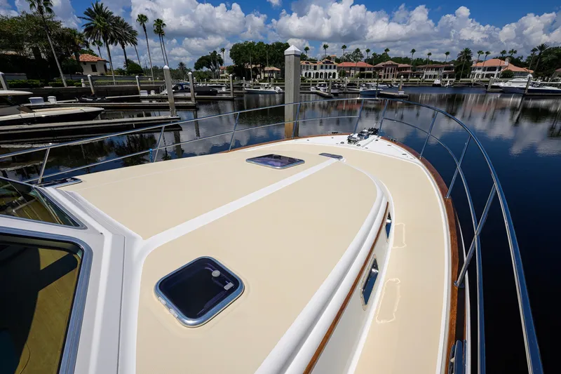 Slide: The Image of 2018 Sabre 45 Salon Express yacht docked in a scenic marina. - 77