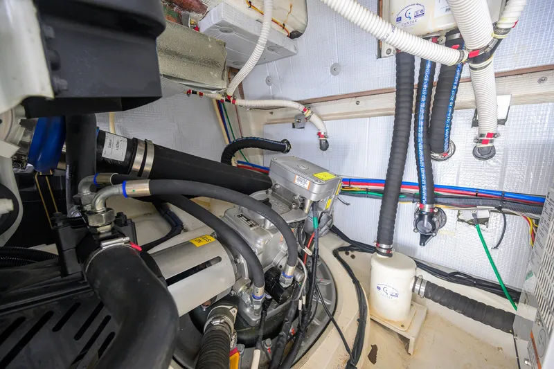 Slide: The Image of Engine room of 2018 Sabre 45 Salon Express yacht, showcasing complex piping and machinery. - 67