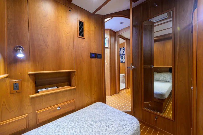 Slide: The Image of Luxurious 2018 Sabre 45 Salon Express cabin interior with wooden finish and cozy bedding. - 20