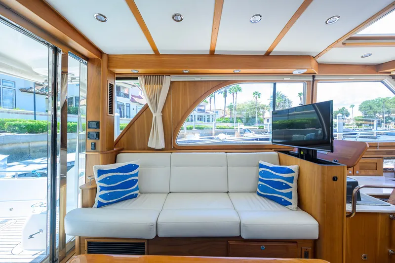 Slide: The Image of Interior of 2018 Sabre 45 Salon Express yacht with white sofa and blue pillows. - 33