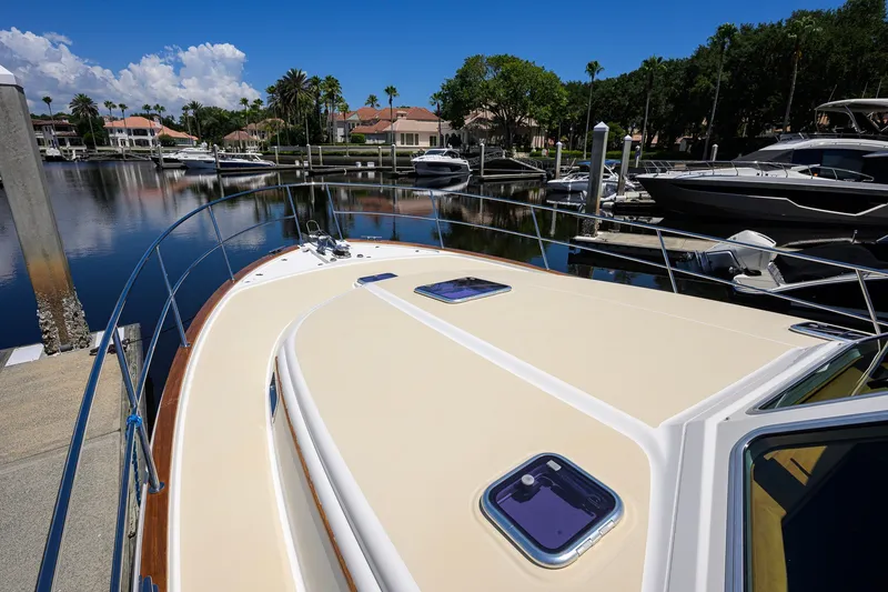 Slide: The Image of 2018 Sabre 45 Salon Express yacht docked in a serene marina setting. - 74