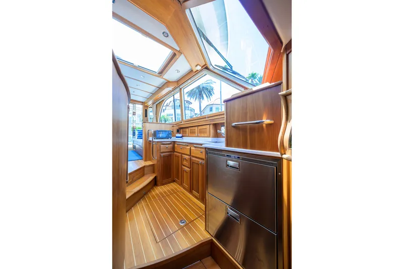 Slide: The Image of Interior of 2018 Sabre 45 Salon Express yacht, featuring elegant wood cabinetry and modern appliances. - 28