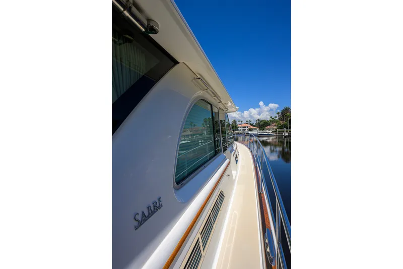 Slide: The Image of 2018 Sabre 45 Salon Express yacht on calm water under clear blue sky. - 72