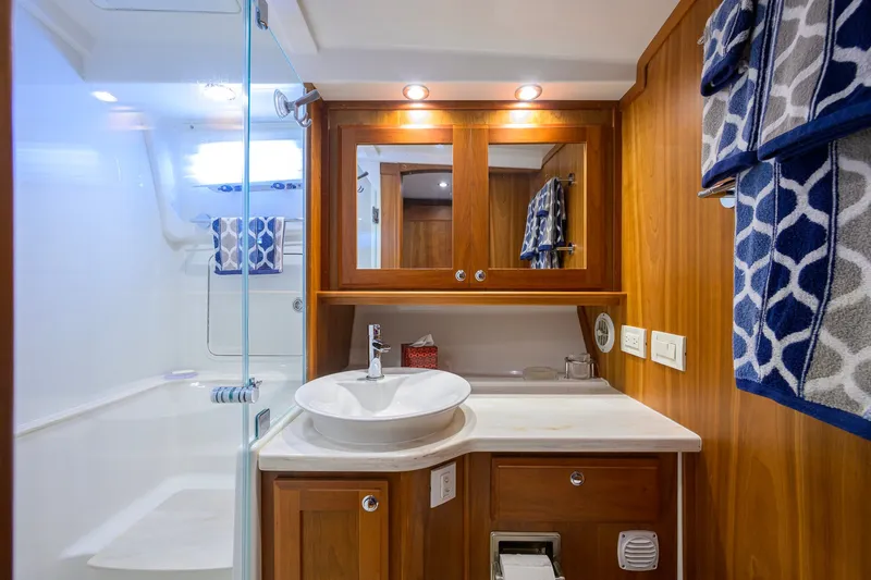 Slide: The Image of Luxurious bathroom in 2018 Sabre 45 Salon Express yacht with wood cabinetry and modern fixtures. - 14