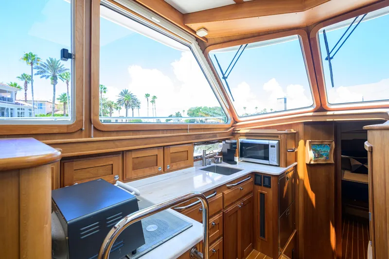 Slide: The Image of Luxurious interior of 2018 Sabre 45 Salon Express yacht with wooden cabinetry and large windows. - 27