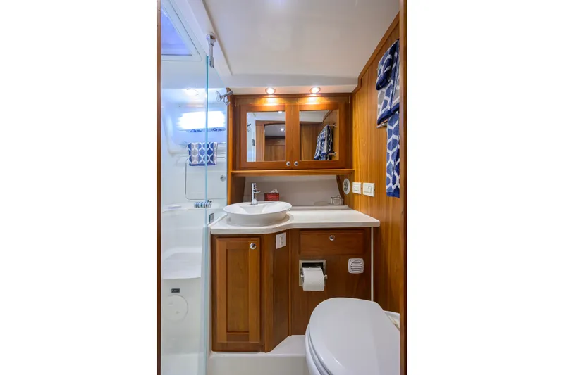 Slide: The Image of Luxurious bathroom in 2018 Sabre 45 Salon Express yacht with wood cabinetry and modern fixtures. - 15