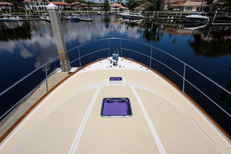 Slide: The Image of Bow view of 2018 Sabre 45 Salon Express yacht docked in a serene marina. - 75