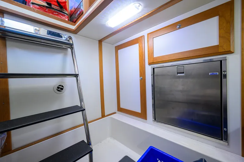Slide: The Image of Interior of 2018 Sabre 45 Salon Express, featuring storage and stainless steel fixtures. - 58