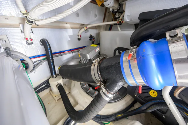 Slide: The Image of Engine room of 2018 Sabre 45 Salon Express with visible hoses and machinery. - 68