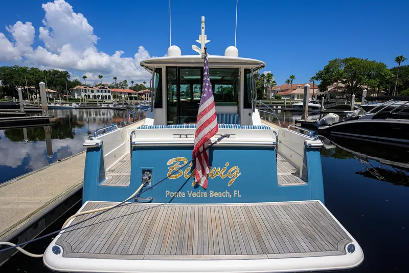 Slide: The Image of 2018 Sabre 45 Salon Express yacht docked, featuring American flag and "Ponte Vedra Beach, FL" text. - 80