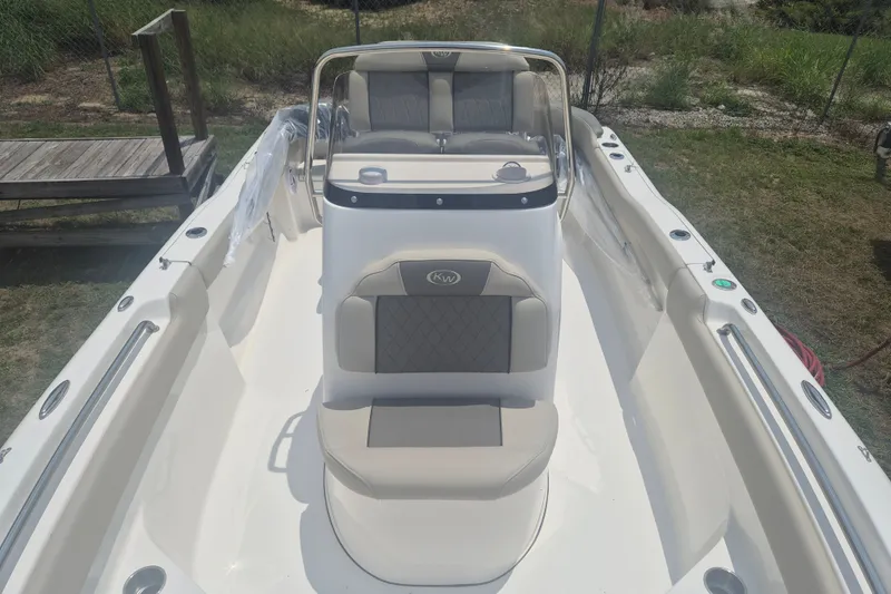Slide: The Image of 2026 Key West 203 FS boat interior with cushioned seating and steering console. - 19