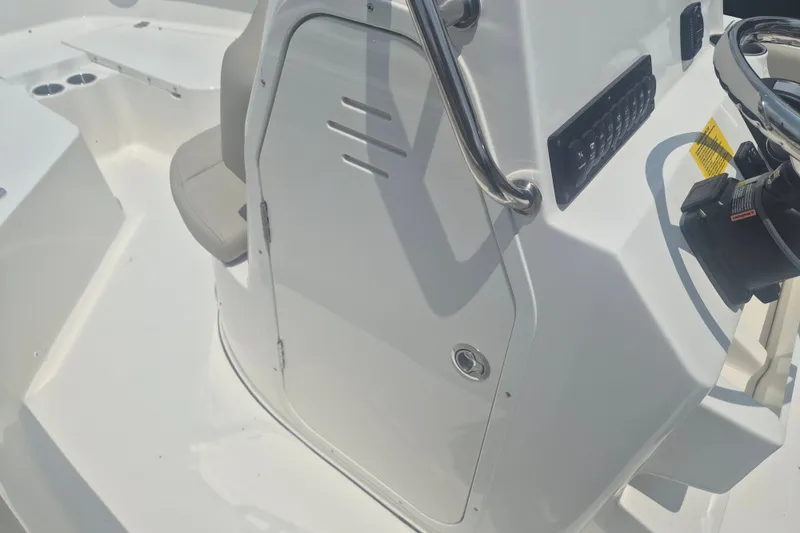 Slide: The Image of 2026 Key West 203 FS boat interior with steering console and seating area. - 14